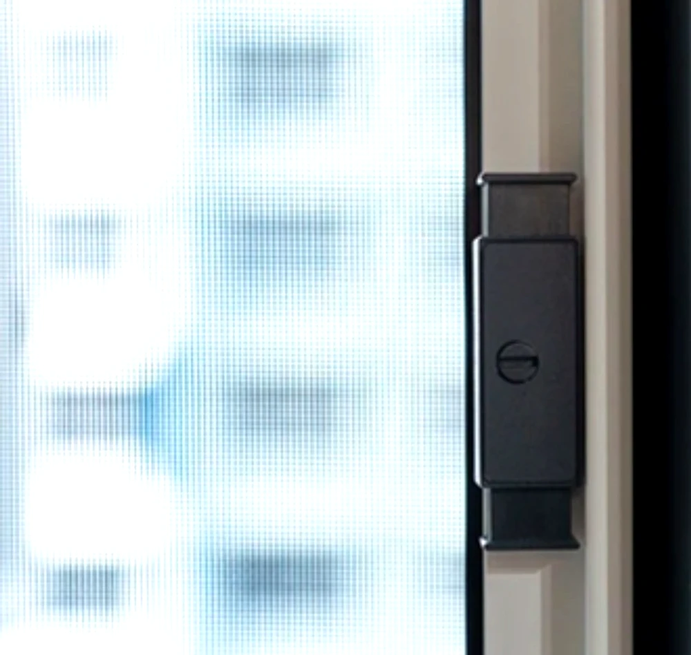 Close view of the slim frame and latch on a bedroom insect mesh installation